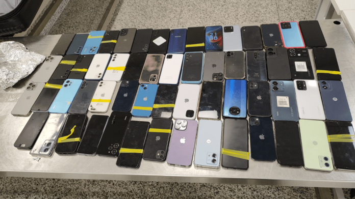 Pai e Filho Detidos em Aeroporto com Centenas de Celulares